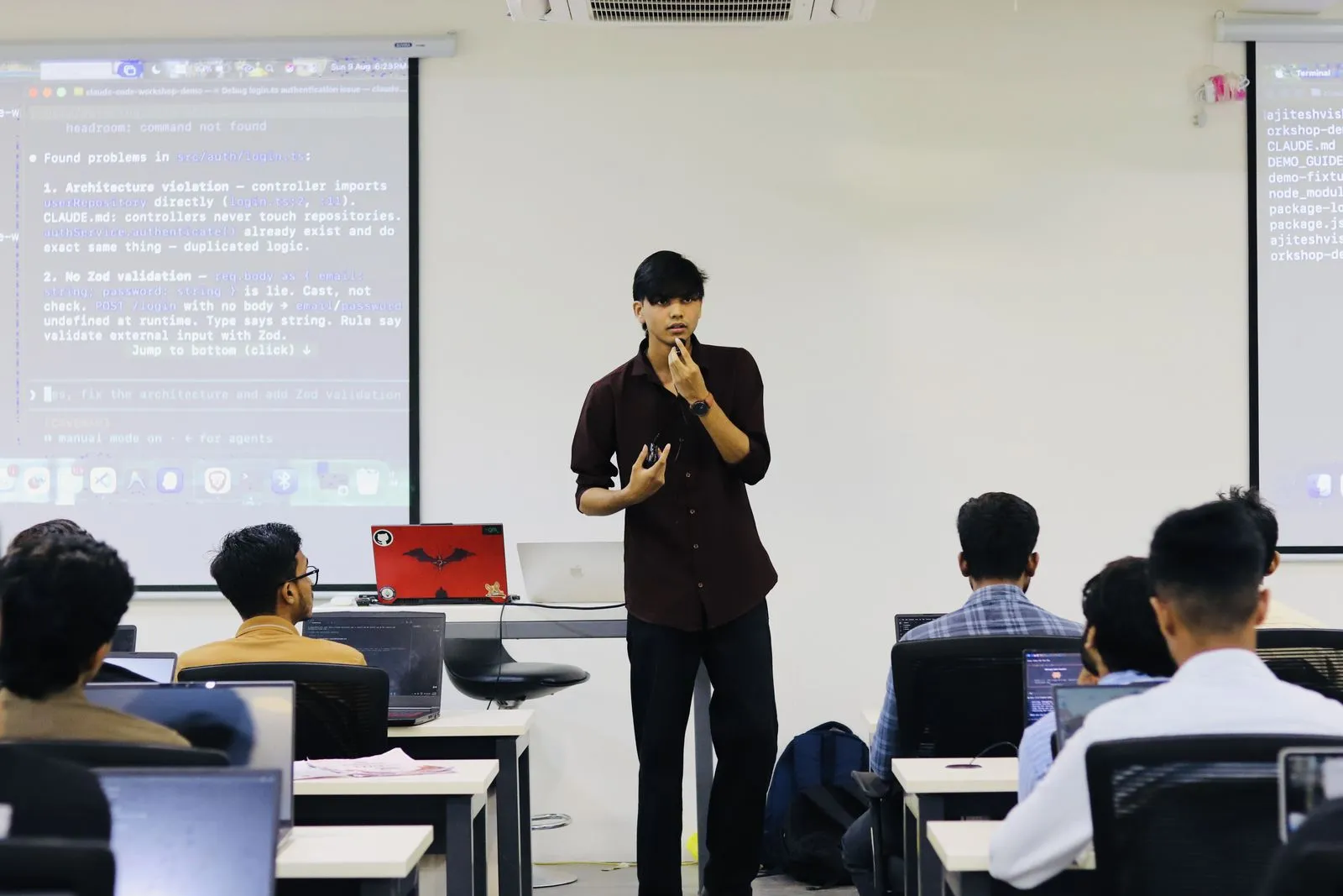 Speaker walking the room through a live Claude Code terminal session projected on the screen at the Claude Code Workshop