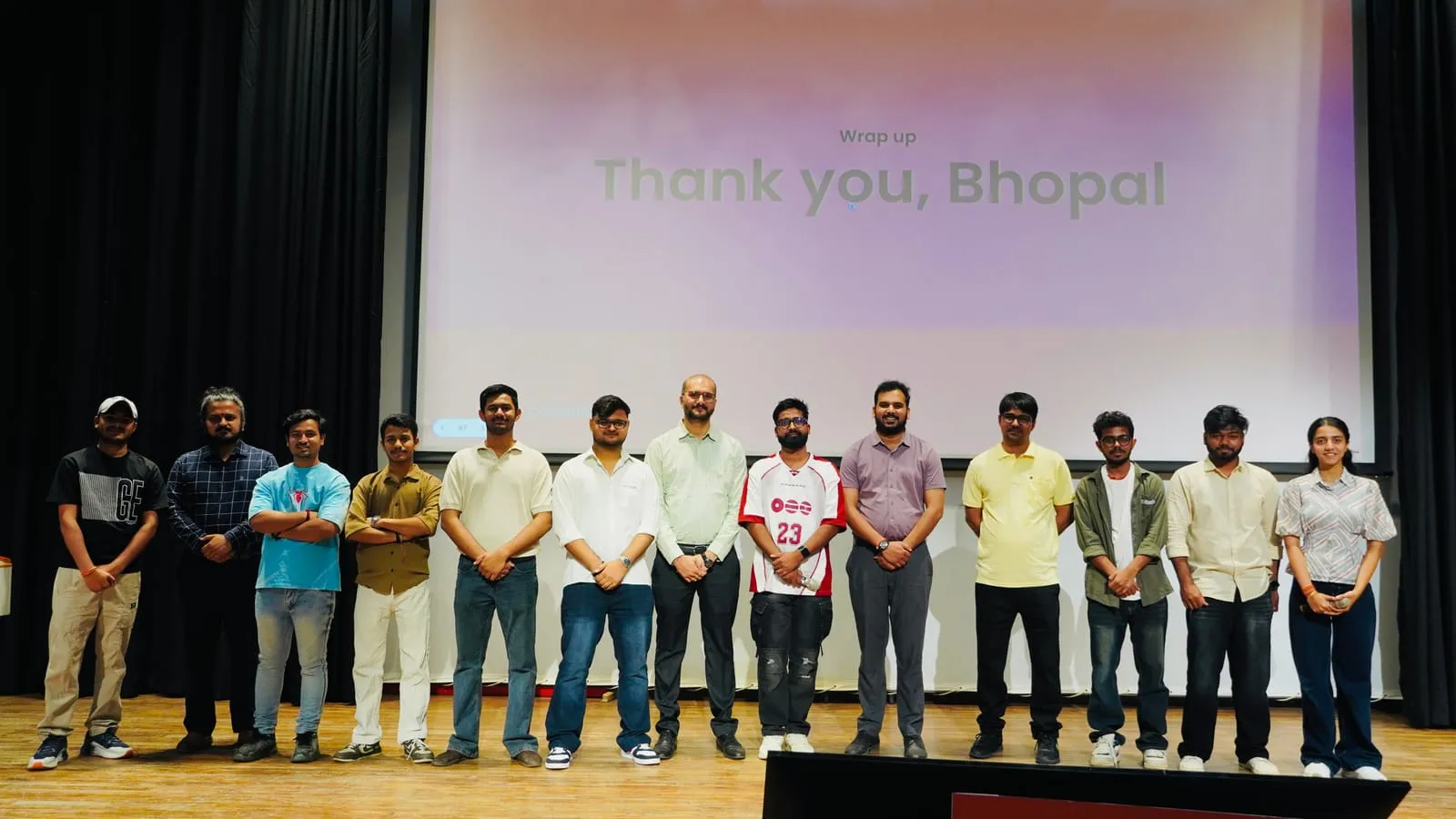 A line of people standing on stage under the Wrap up, Thank you, Bhopal slide